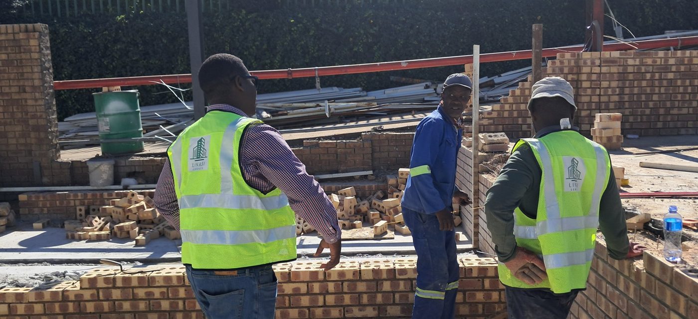 Linasi site manager inspecting brickwork with the team