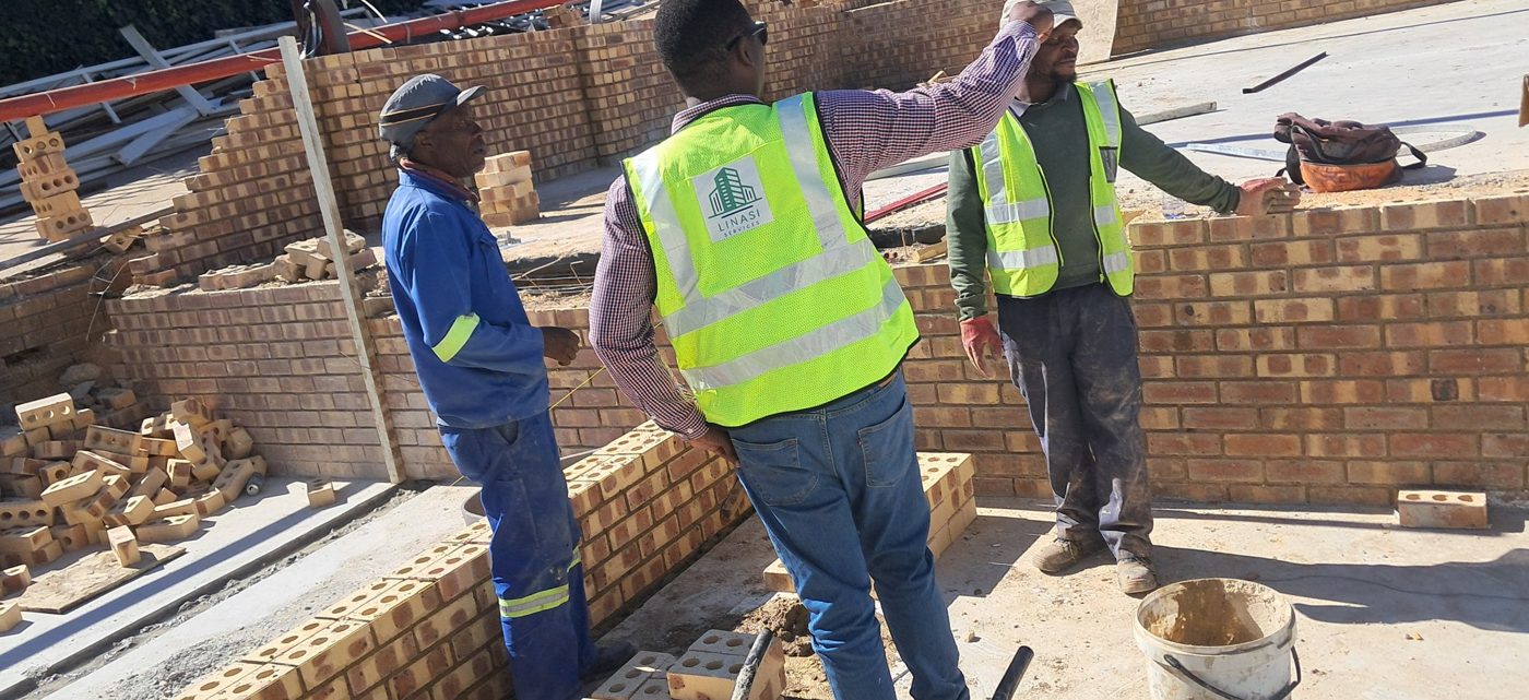 Linasi team reviewing work on site